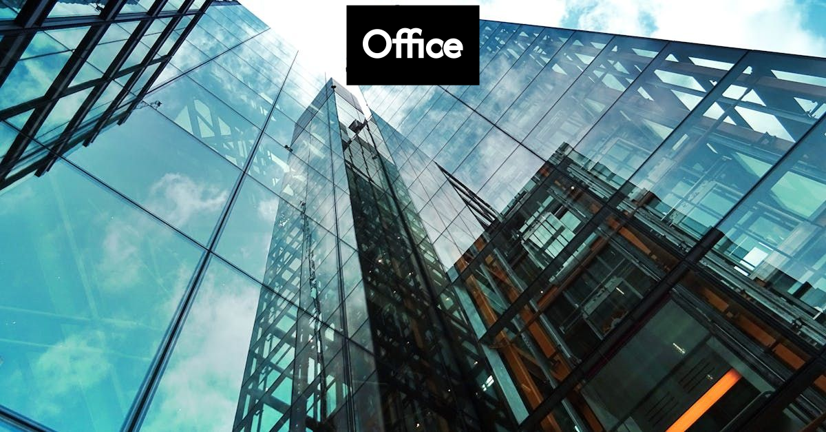 Modern office with standing desks and collaborative areas.