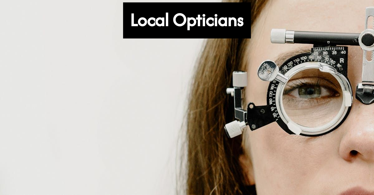 Optician helping client in modern optical shop