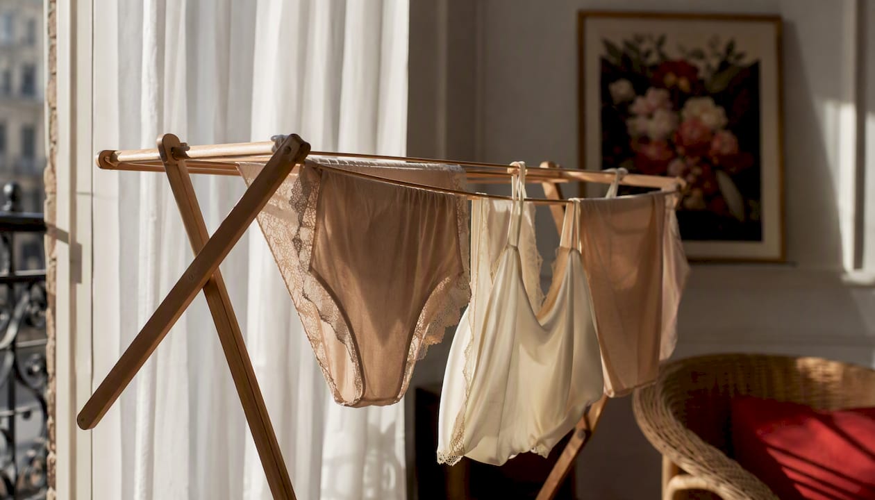 Des sous-vêtements étendus à sécher près de la fenêtre, à l’intérieur.