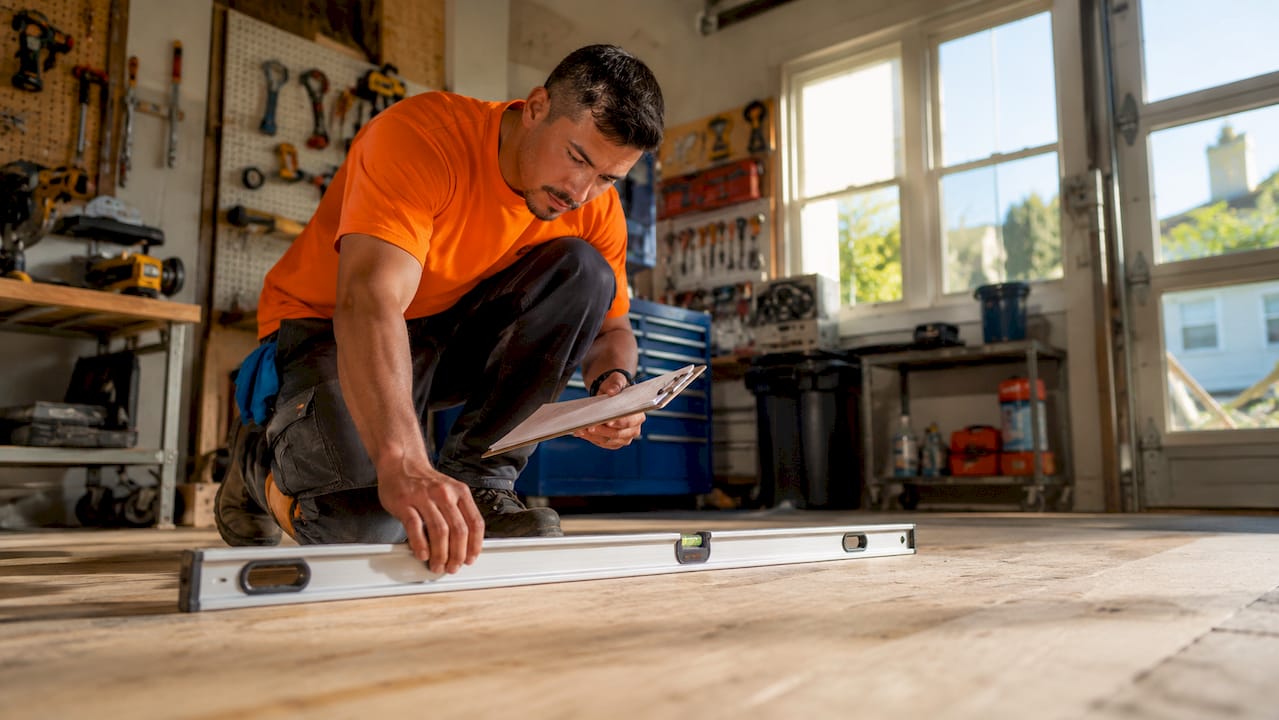 Flooring expert measuring subfloor flatness