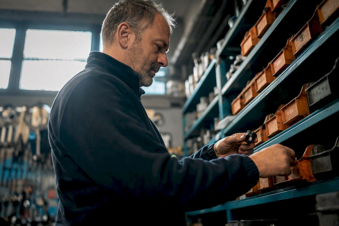 Mains comptant le stock de pièces de vélo dans l'atelier