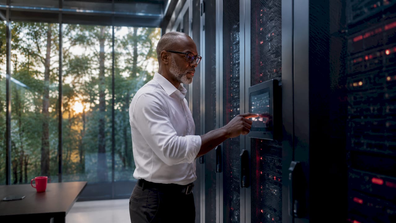 Hands adjusting server in data center