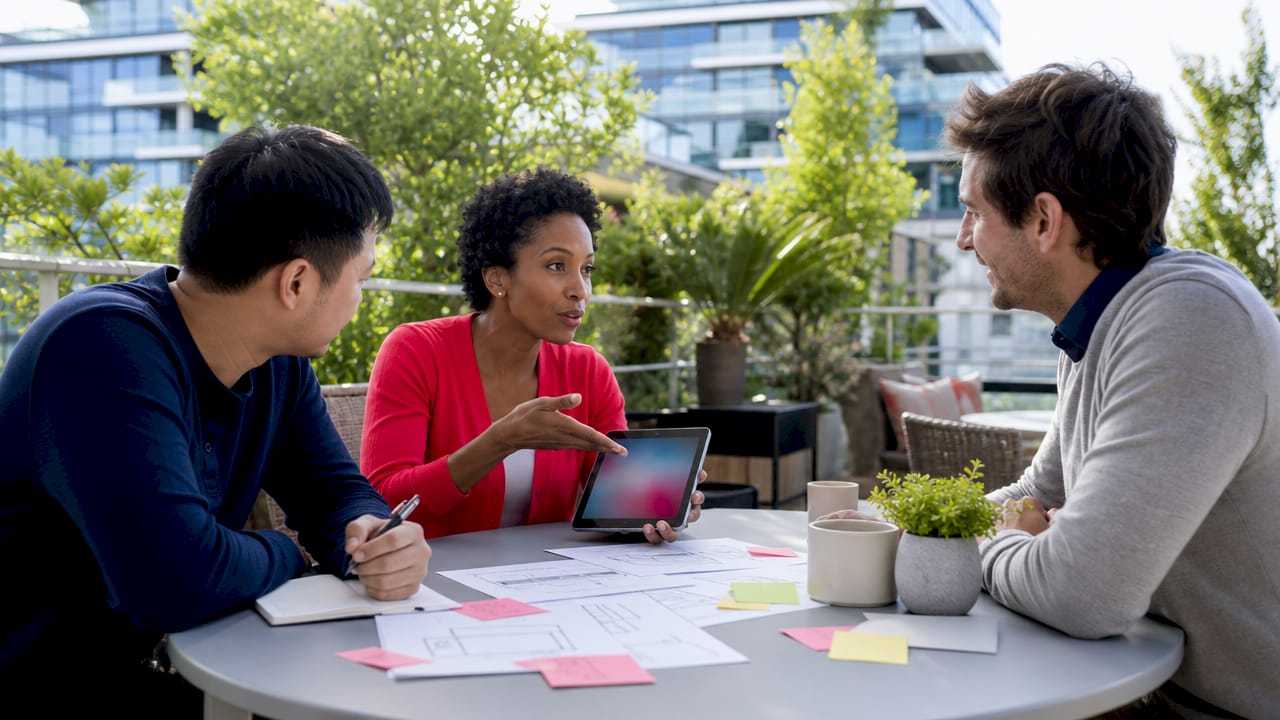 Team collaborating on UX design in meeting room