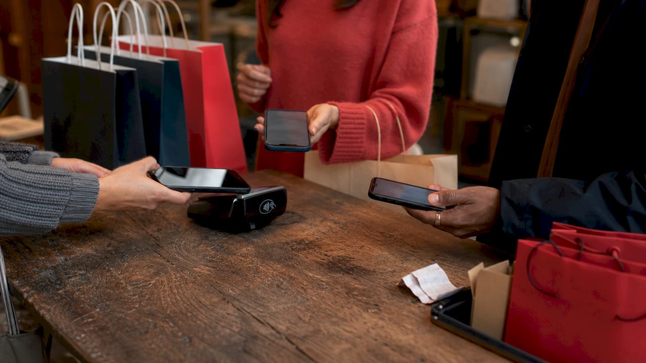 Close-up of hands using smartphones for shopping