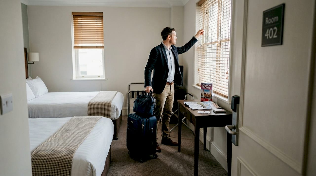 Business traveler entering hotel room layout