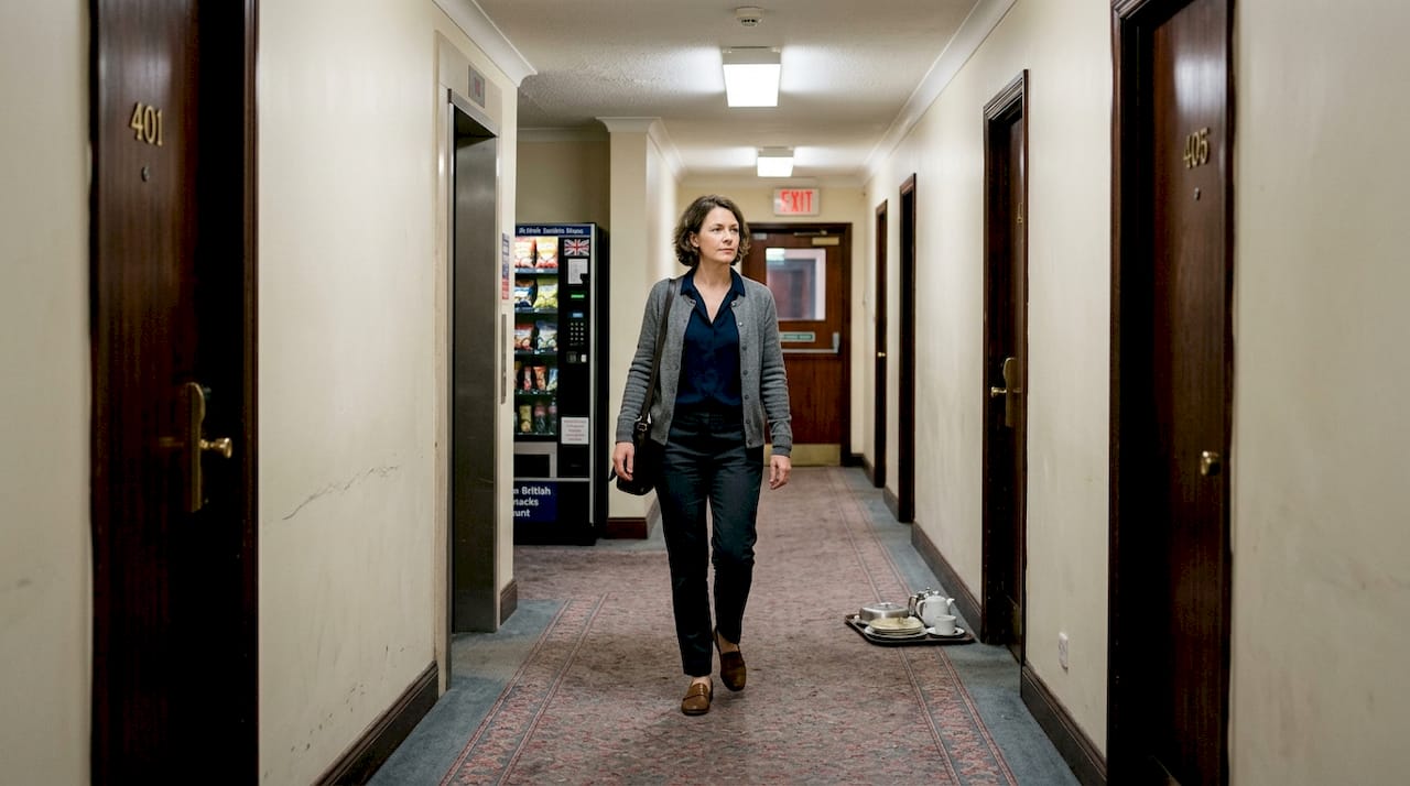 Guest walking hotel hallway near safe rooms