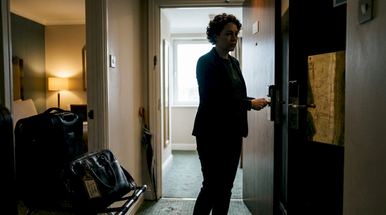 Traveler securing hotel room door with bag inside