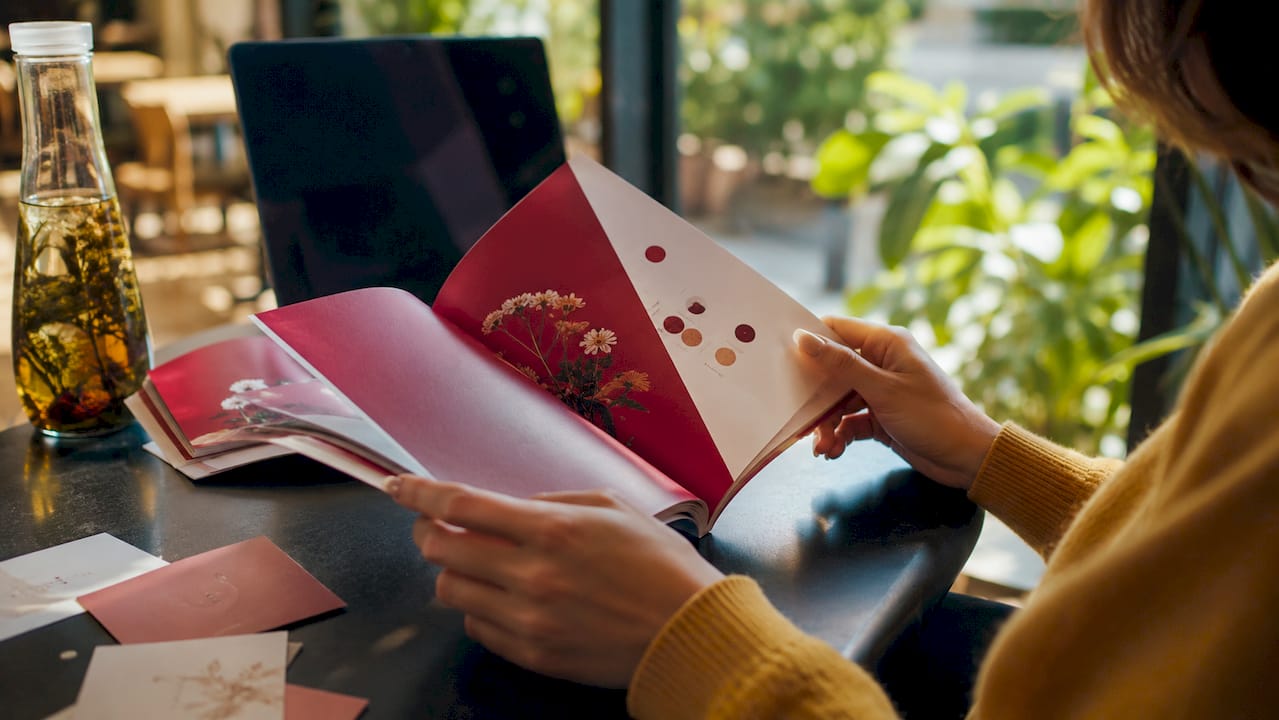 Hands reviewing vegan ingredient specifications at desk