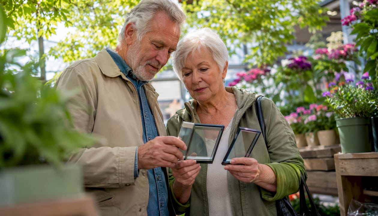 Elderly couple comparing window brochures in showroom