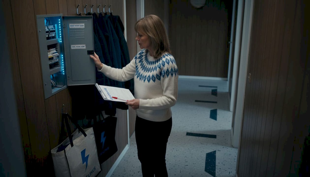 Woman inspects home electrical panel