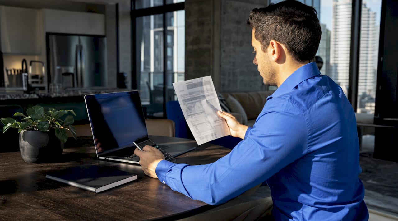 Man calculating home energy consumption bills