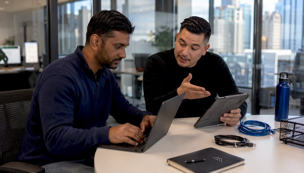 Two IT technicians planning endpoint detection setup