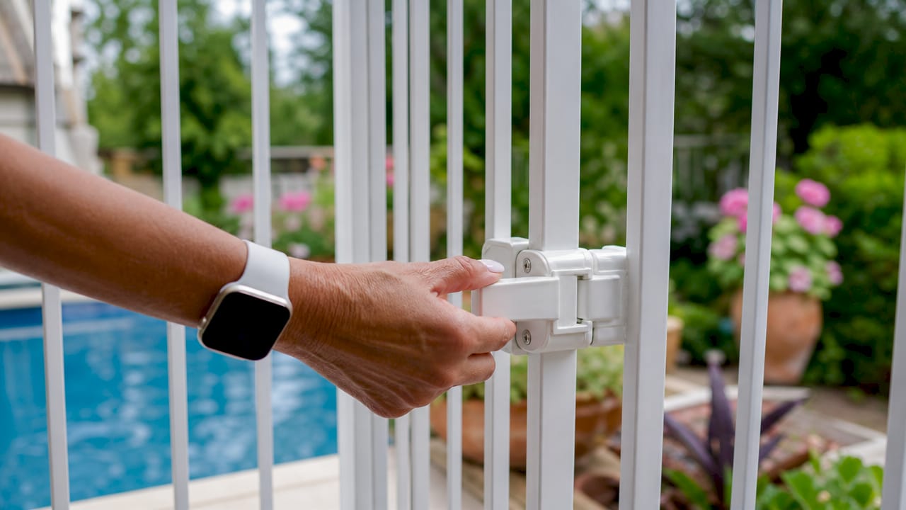 Close-up hand locking pool safety gate latch