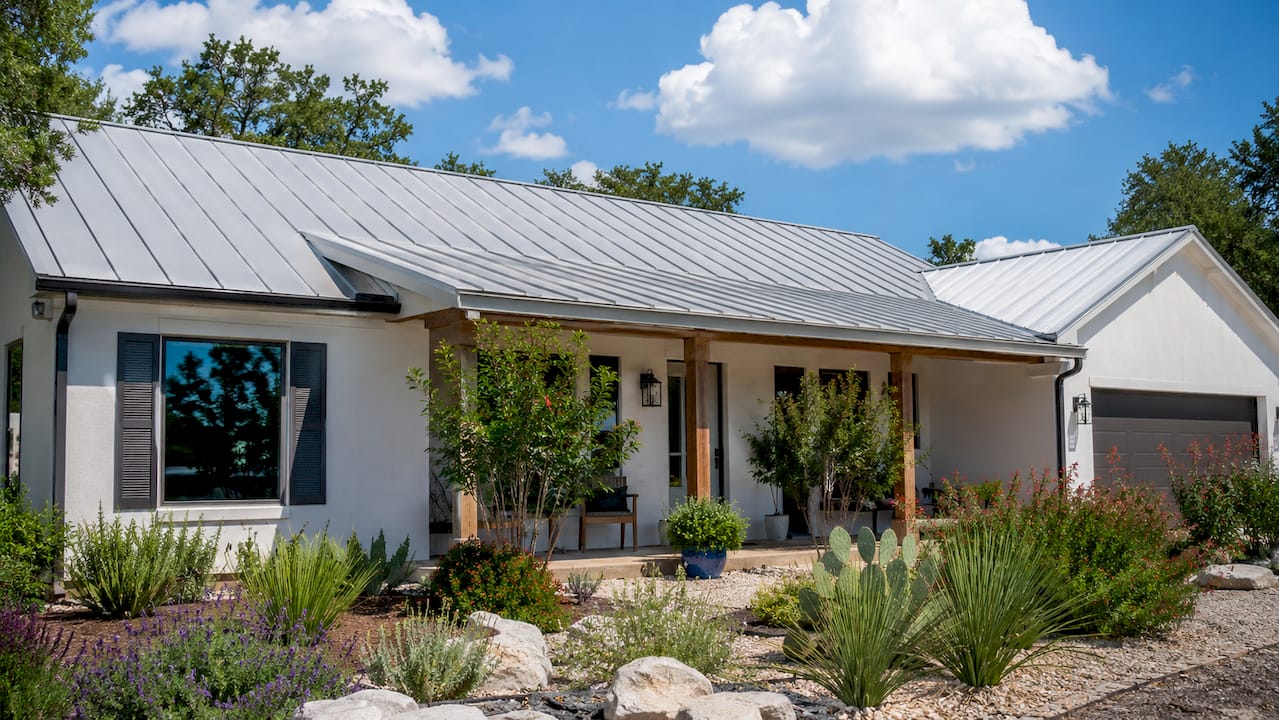 Texas home with standing-seam metal roof in sunlight