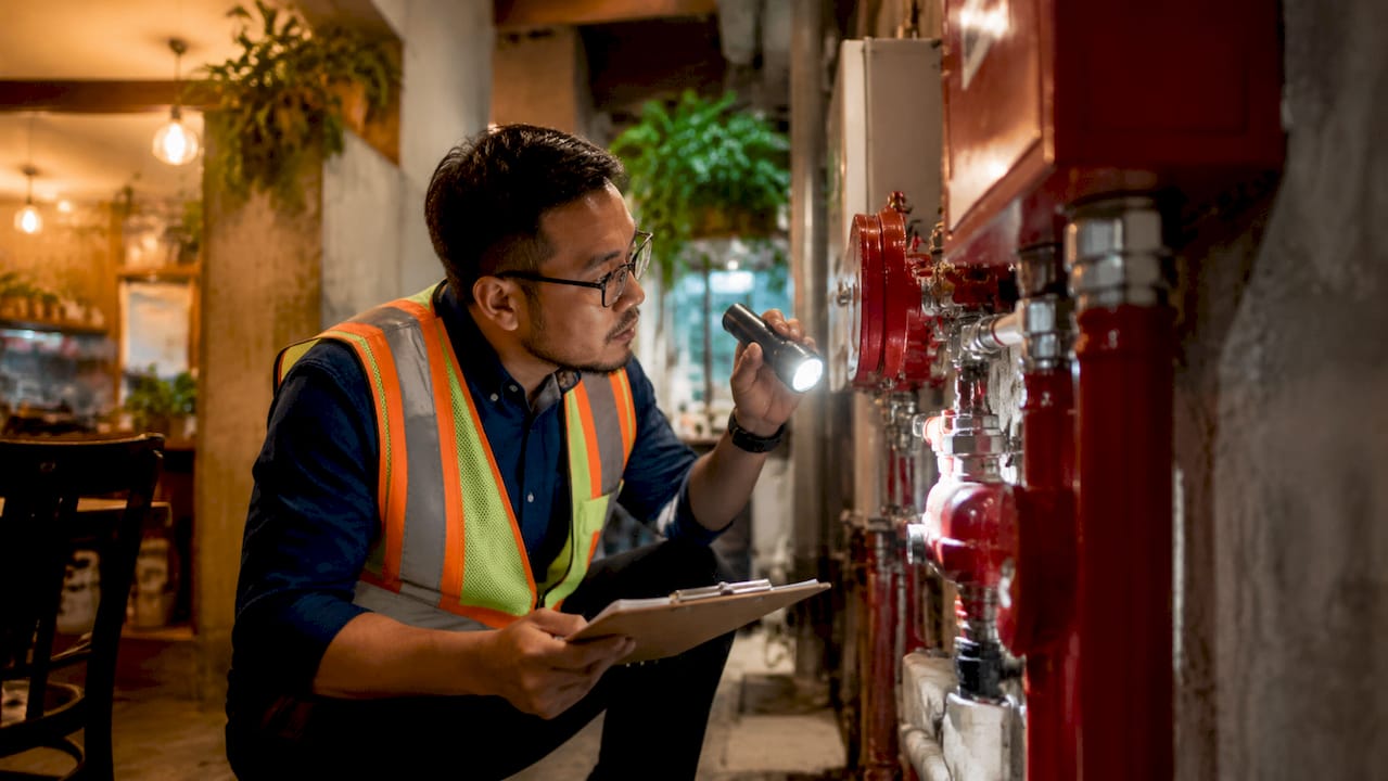 Technician inspecting fire sprinkler system