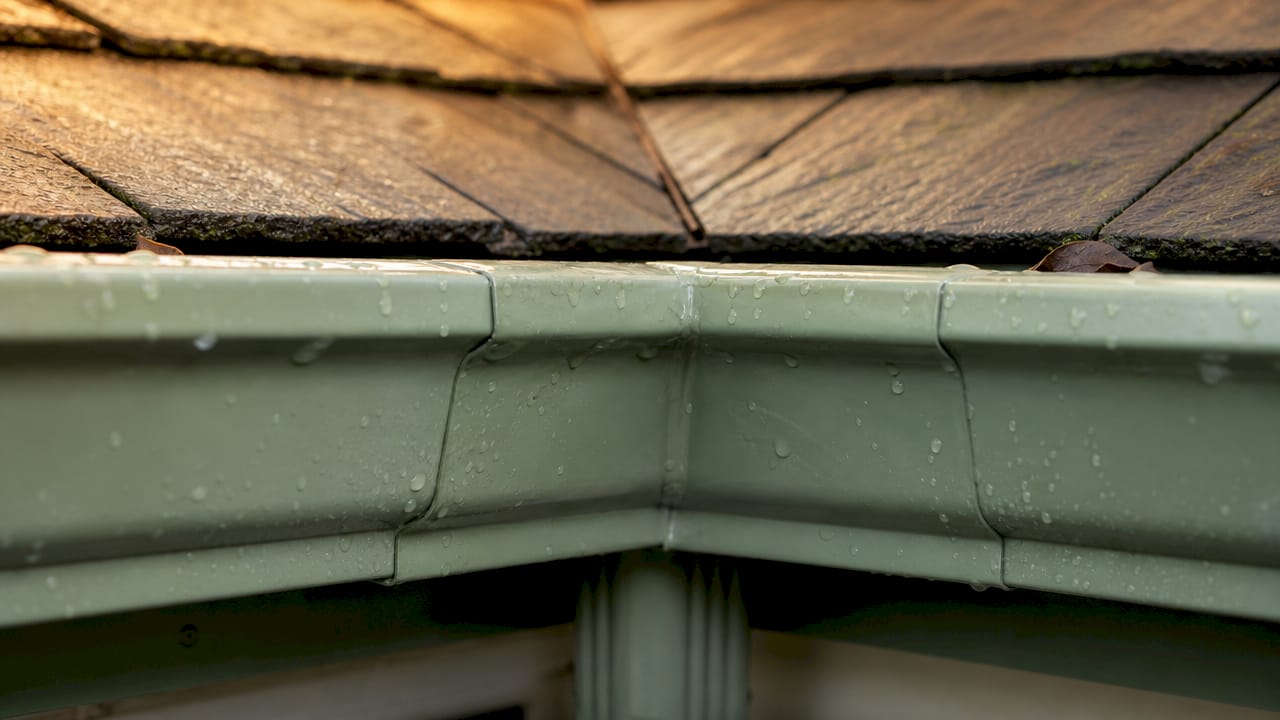 Close-up of wet aluminum inside gutter corner joint