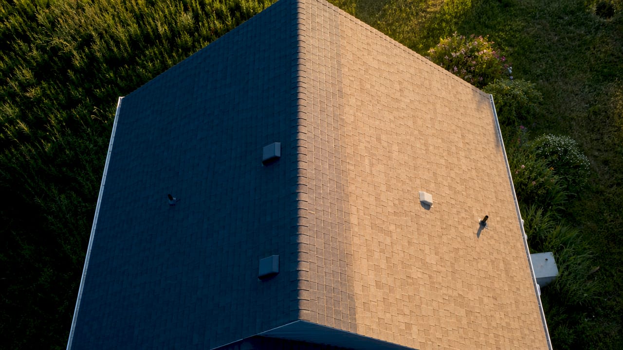 Overhead view of dark and light roof shingles side by side