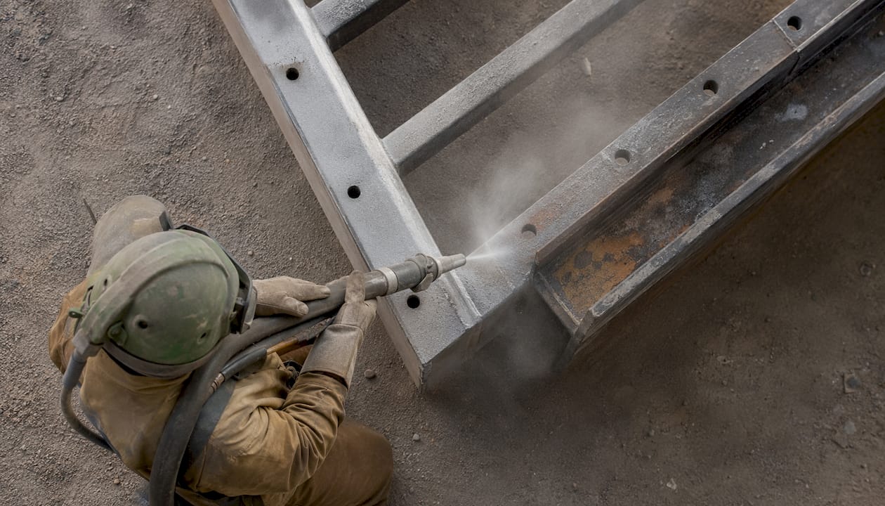 Worker blasting surface for paint preparation