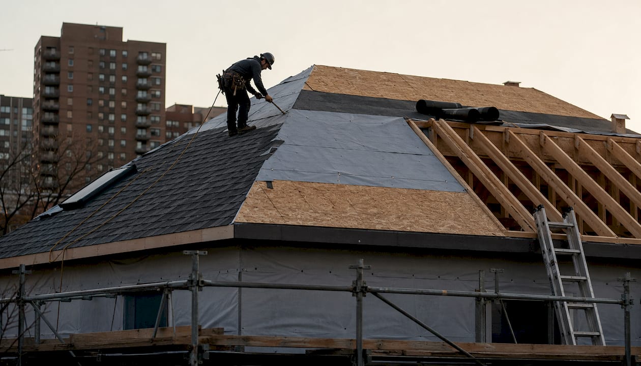 Close-up layered roof construction showing sheathing and shingles
