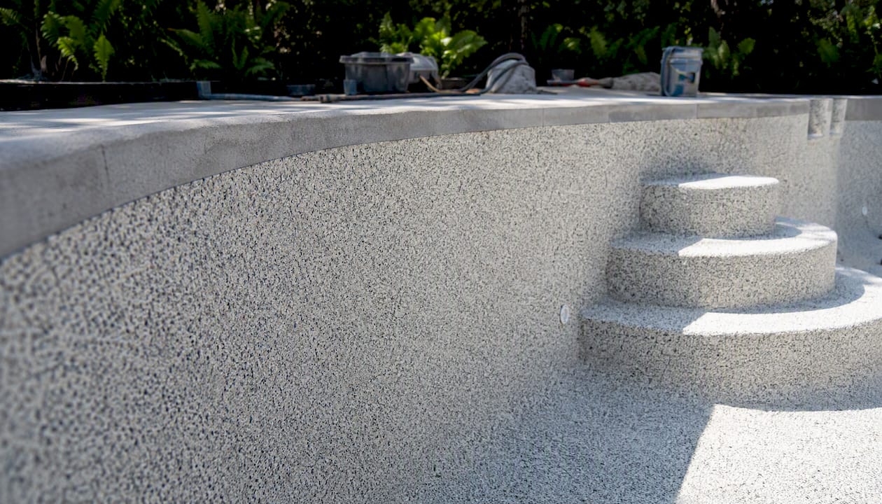 Best T&D Pools Alternatives for Central Florida Homeowners 1 Textured pebble finish on concrete pool surface