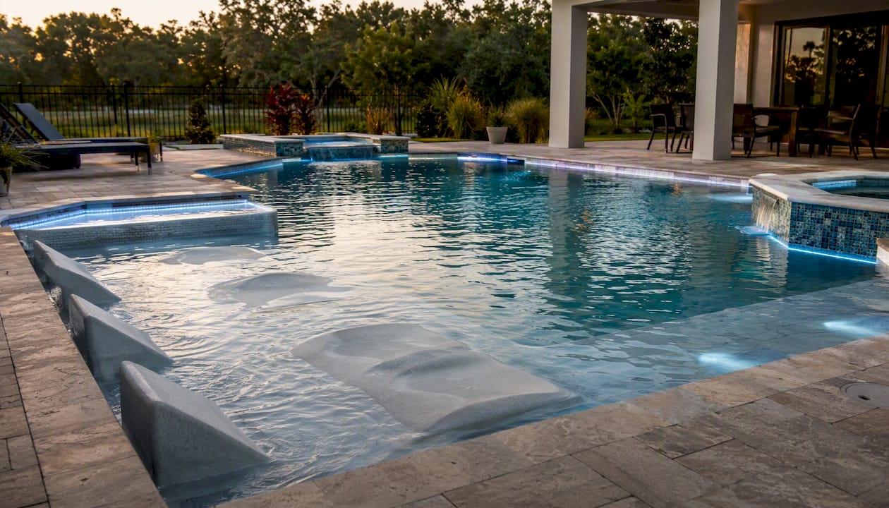 Narrow Yard Pool Designs: Space-Saving Ideas That Work 2 Tanning ledge and swim-jet feature in pool