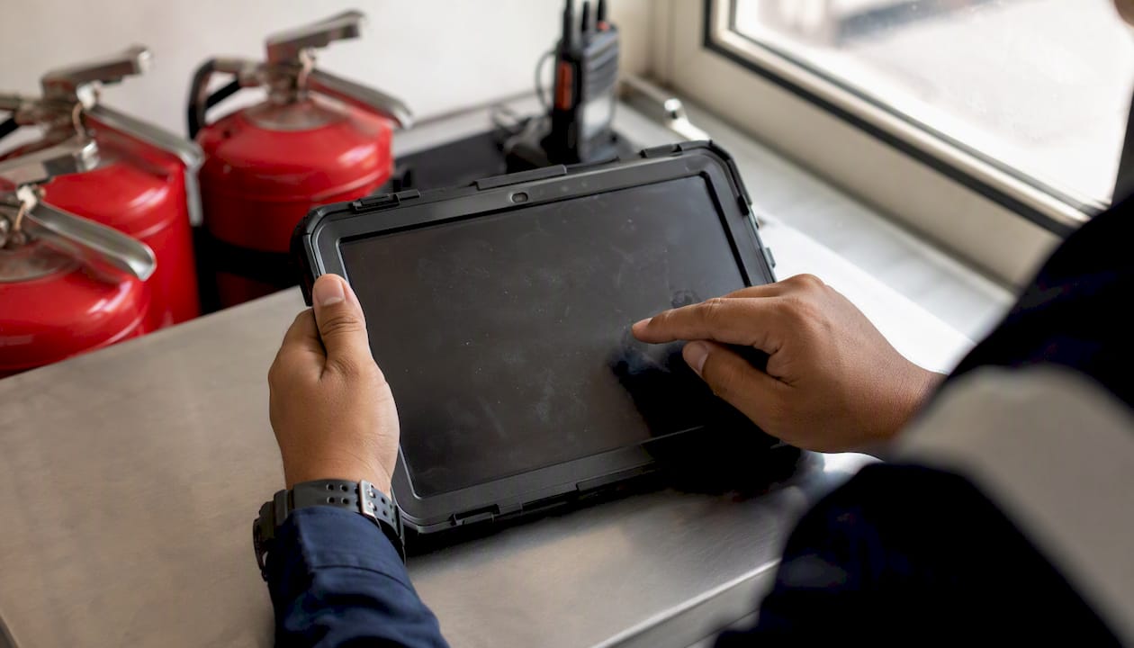 Hands logging patrol on tablet