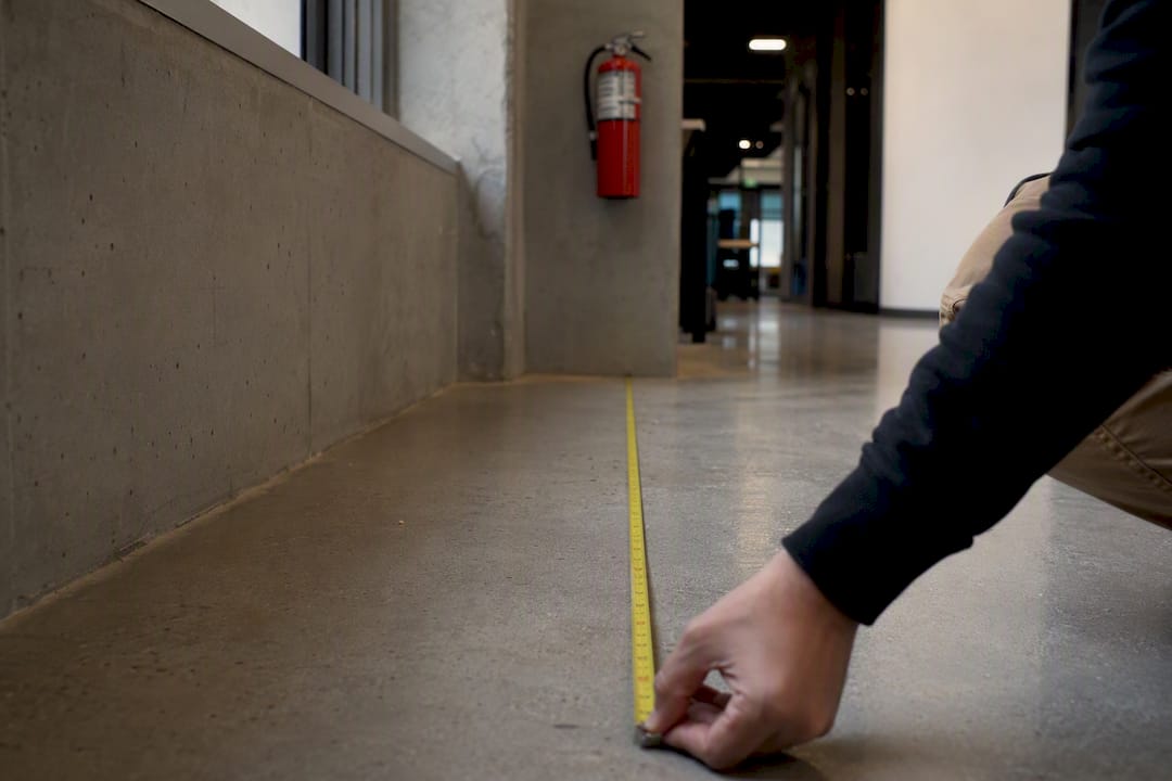 Tape measure showing distance to fire extinguisher