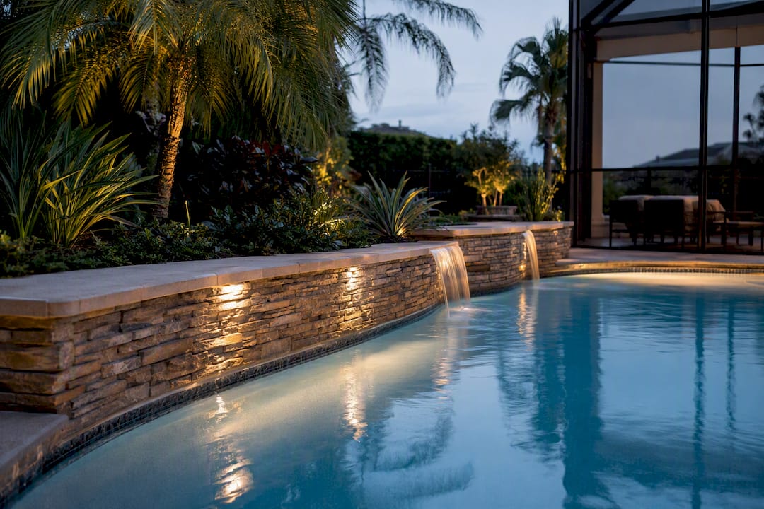 Do You Need a Retaining Wall for Your Pool? 2 Tiered stone veneer retaining wall with water feature