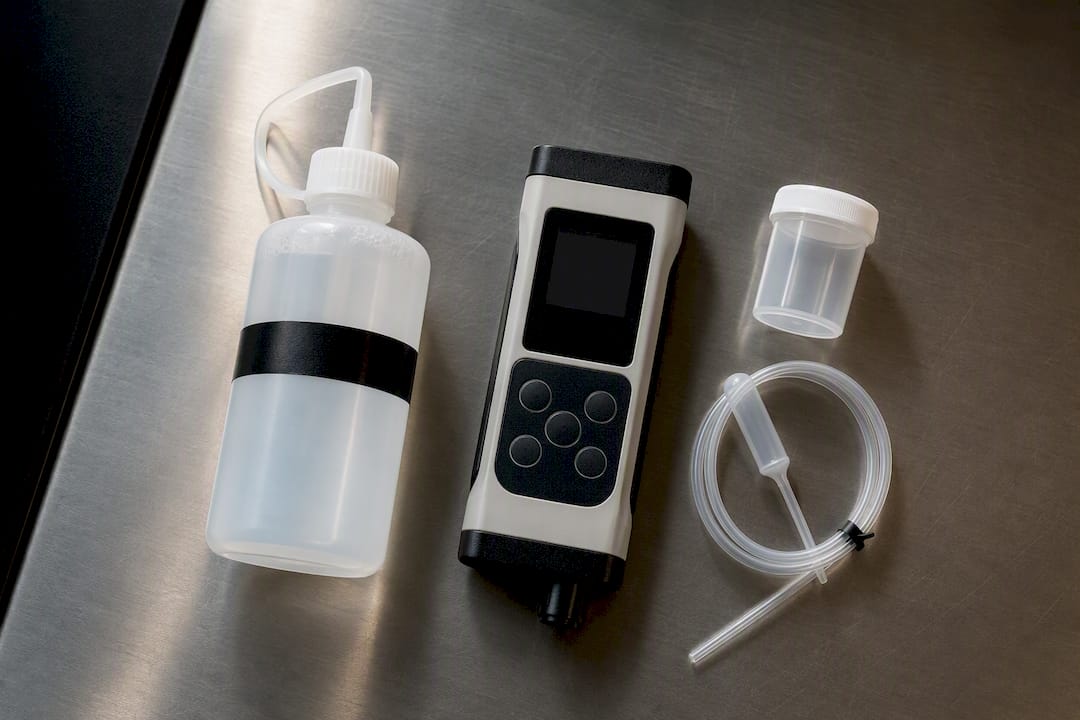 Dedicated deionized water bottle beside meter