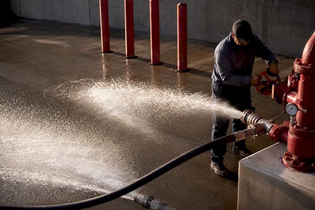 Technician conducting annual fire pump flow test