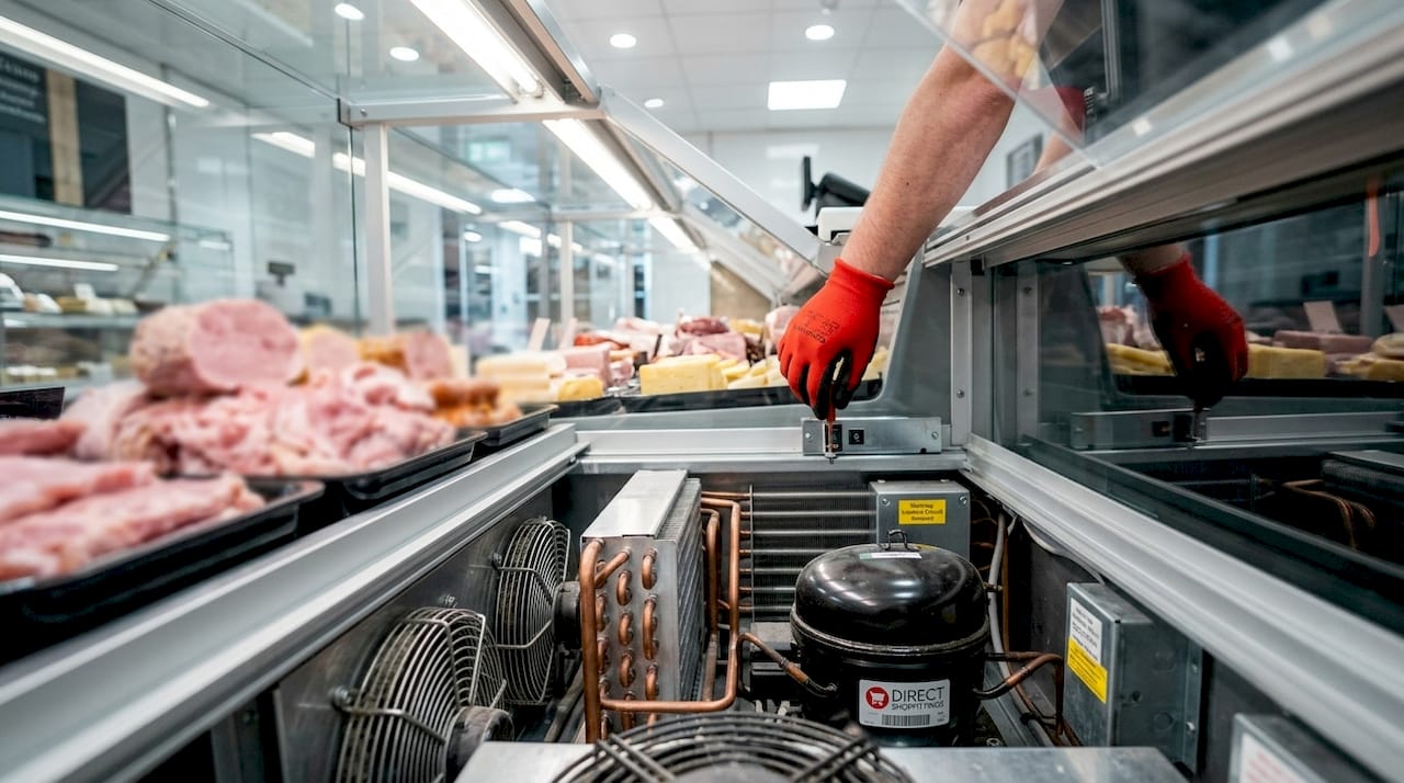 Close-up of deli display case refrigeration components
