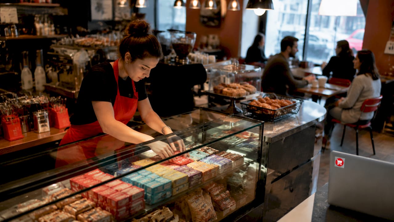 Employee stocking countertop display cabinet