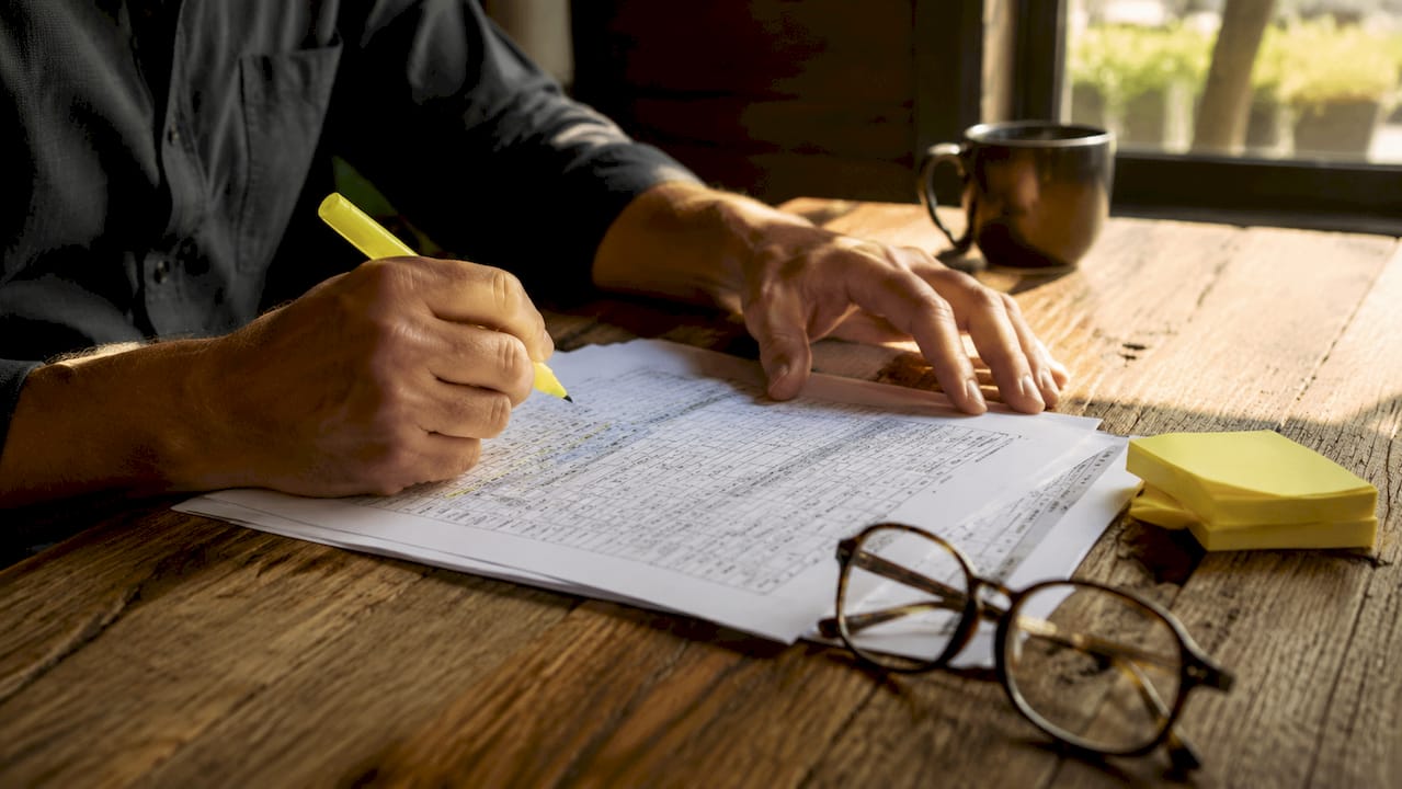 Hands highlighting sales audit report