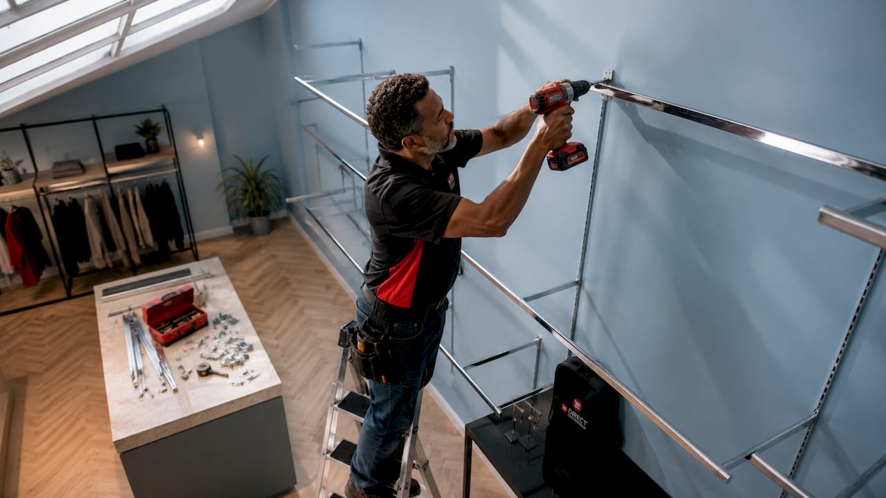 Essential shopfitting supplies list for small retailers 1 Technician installing garment rails in store