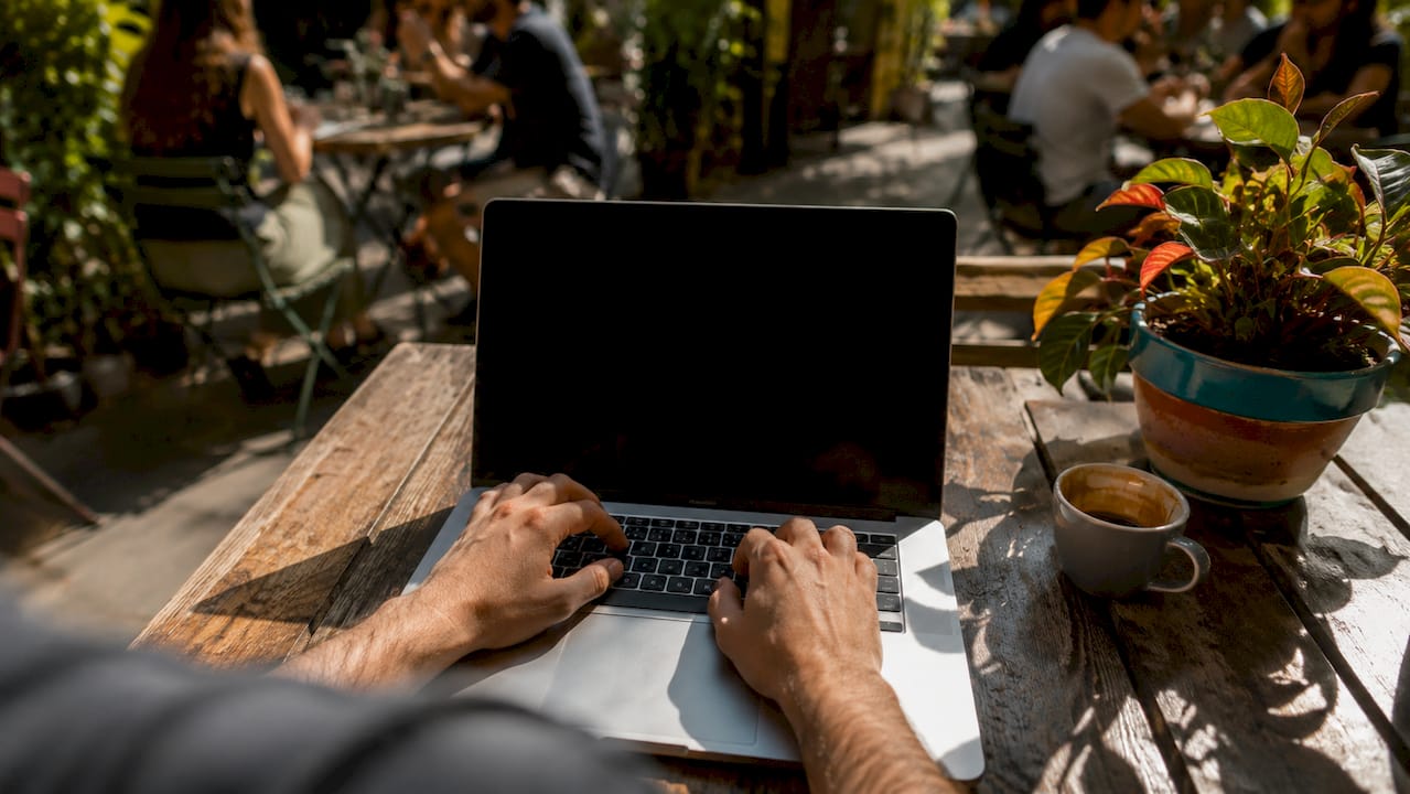 Developer typing payment gateway code on laptop