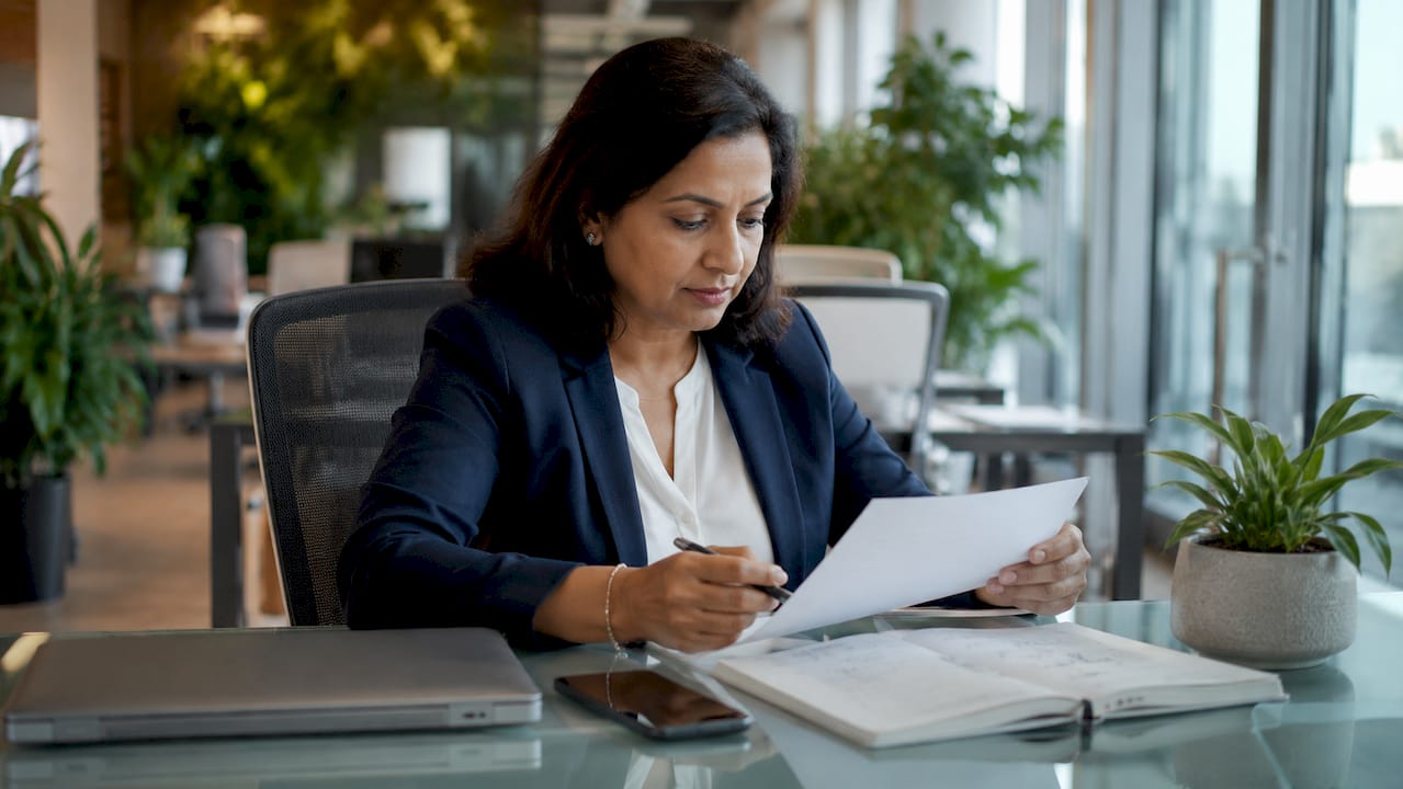 Business manager reviewing POS hardware checklist