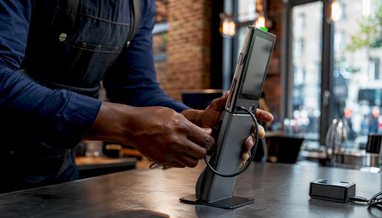 Retail technician installing POS encryption device