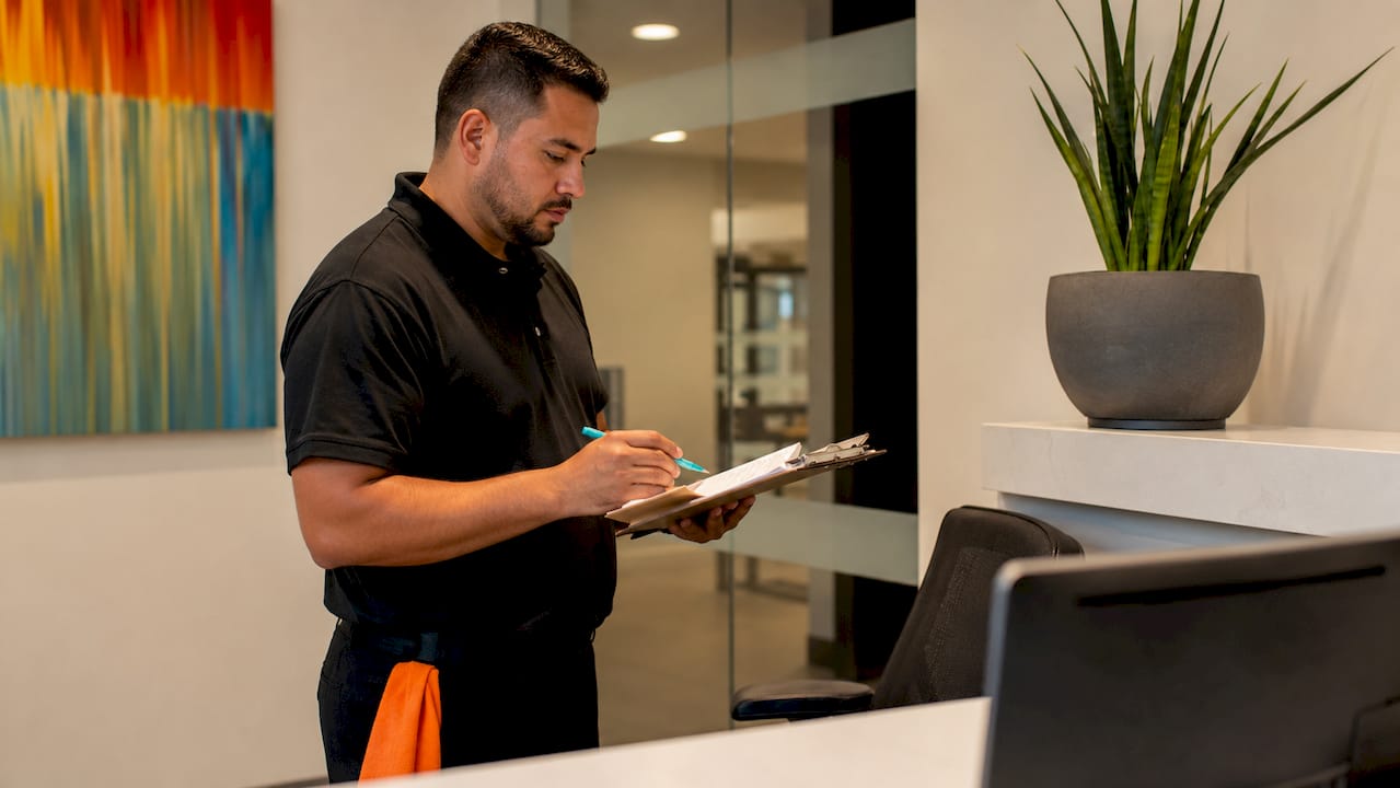 Cleaning supervisor reviewing checklist clipboard