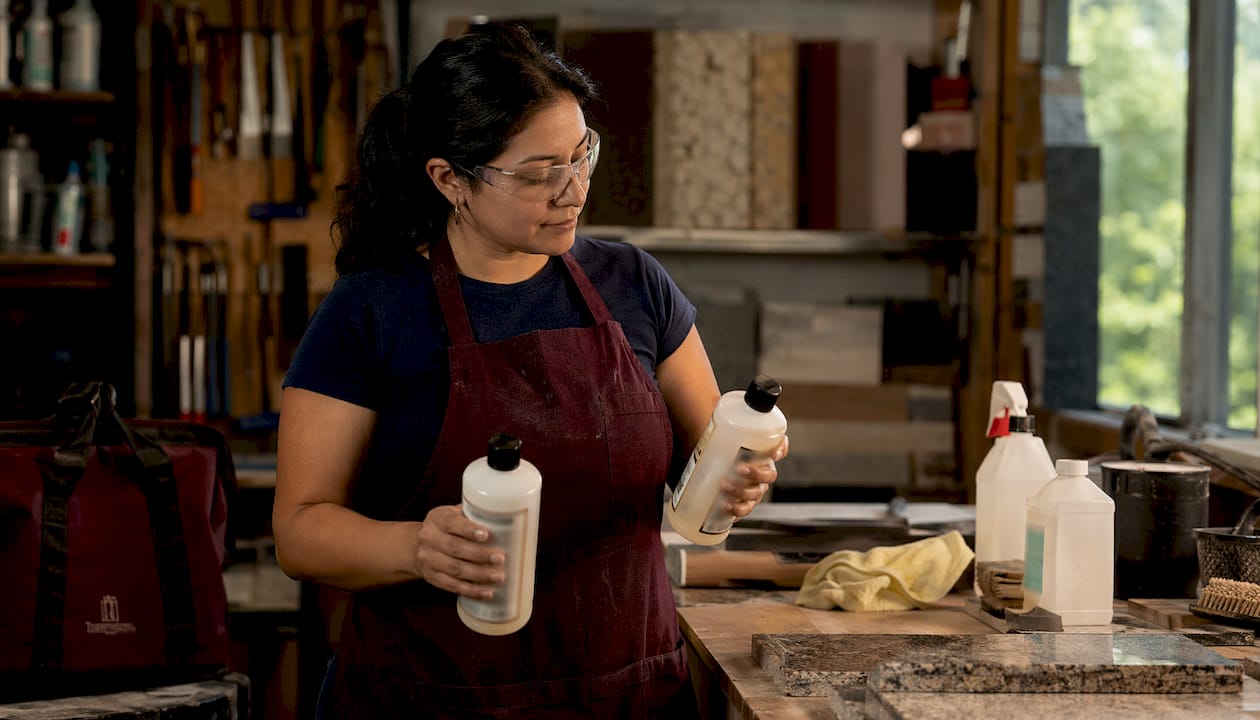 How To Seal Granite Countertops: 2026 New Mexico Guide 1 Woman Comparing Granite Sealer Types