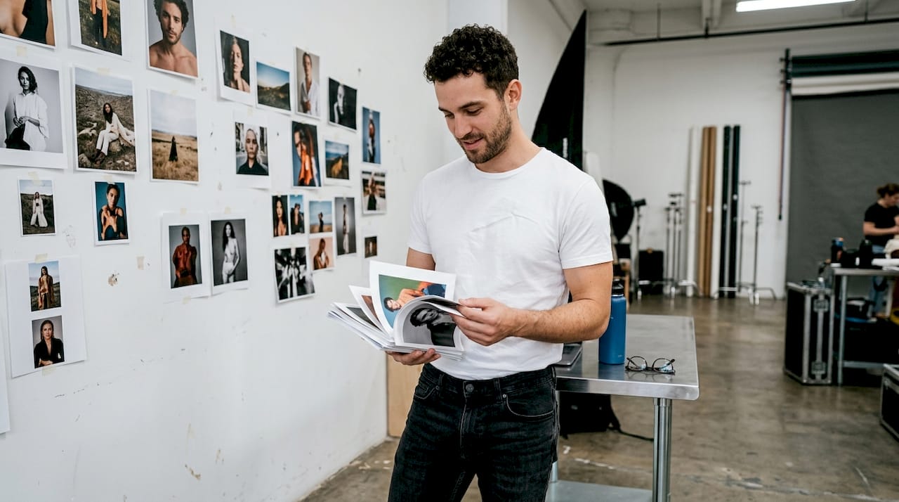 Male model choosing portfolio photos in studio