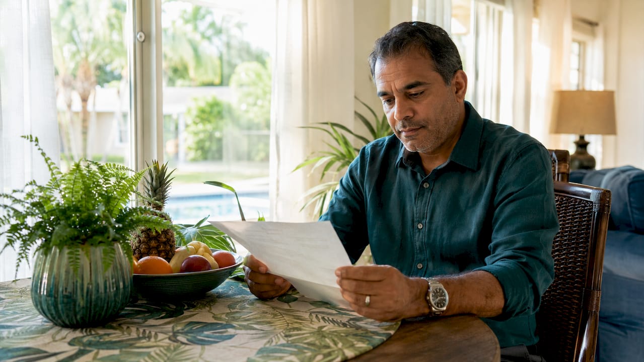 What Is Electronic Rent Payment: 2026 Renter's Guide 1 Hands holding rent payment receipt on desk