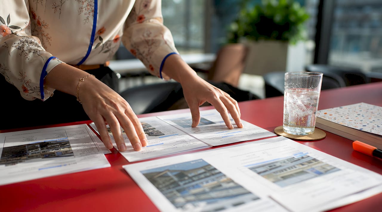 Overhead view of agent sorting commercial inspection papers