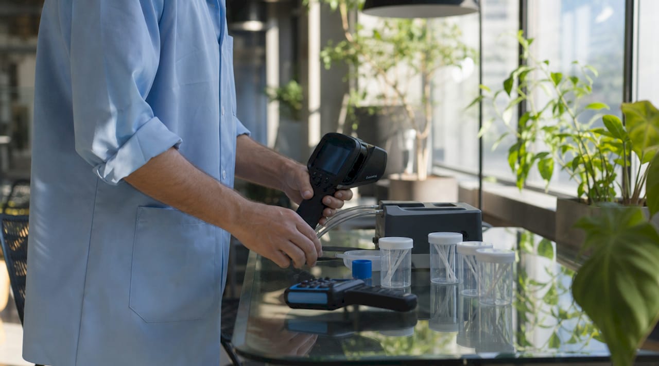 Close-up of hands arranging professional mold testing tools