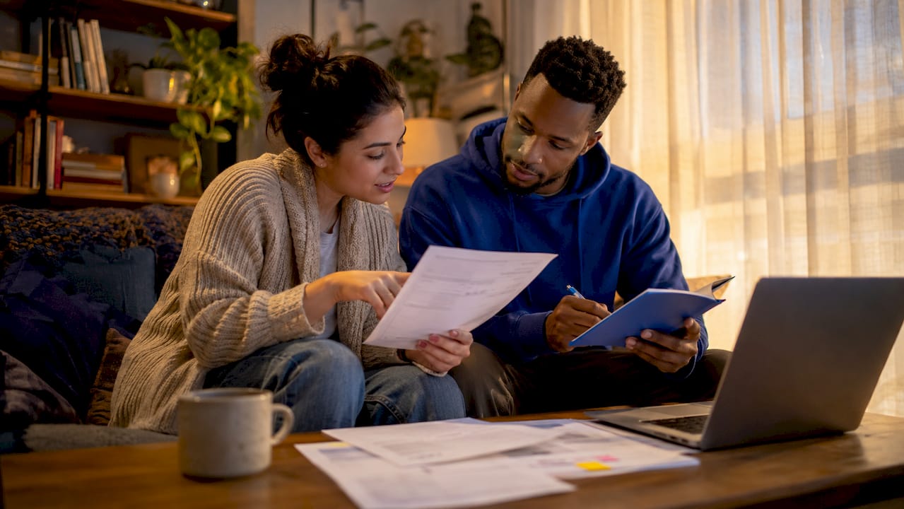 Couple reviewing new home warranty paperwork