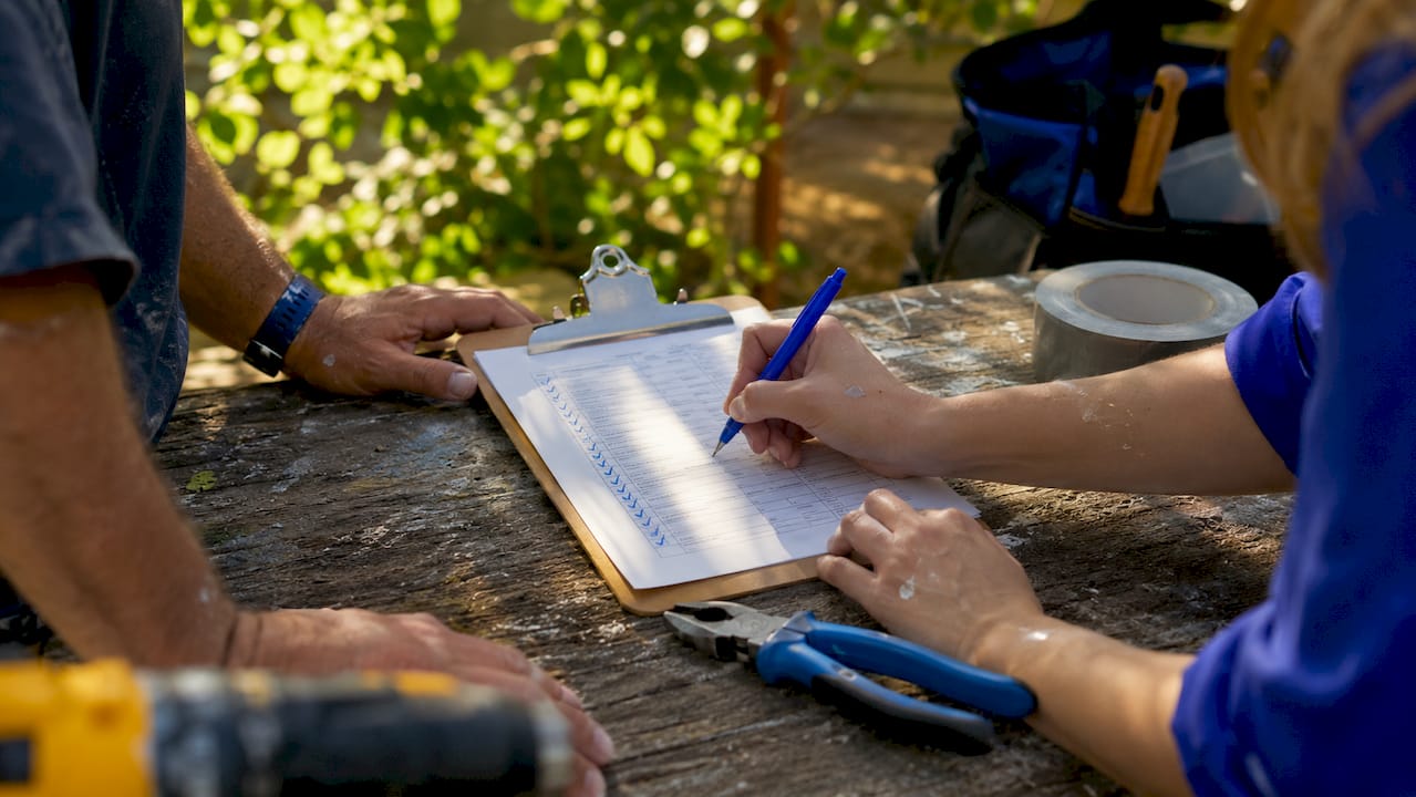 Hands holding home inspection checklist