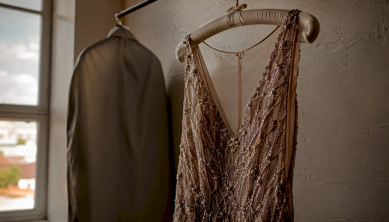 Beaded dress hanging on padded hanger