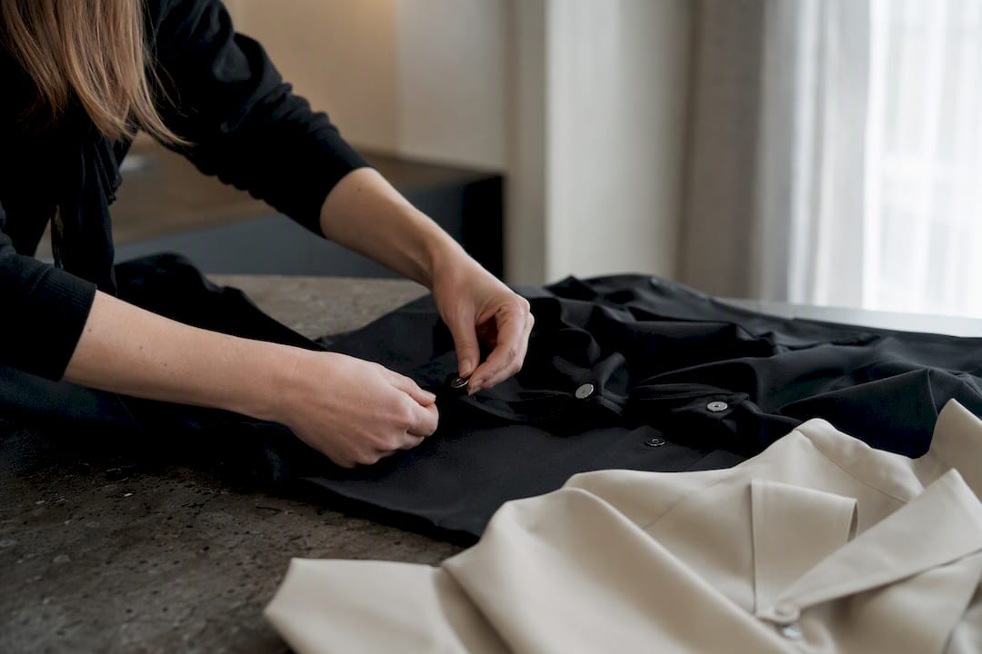 Hands adjusting adaptive clothing magnetic and Velcro closures