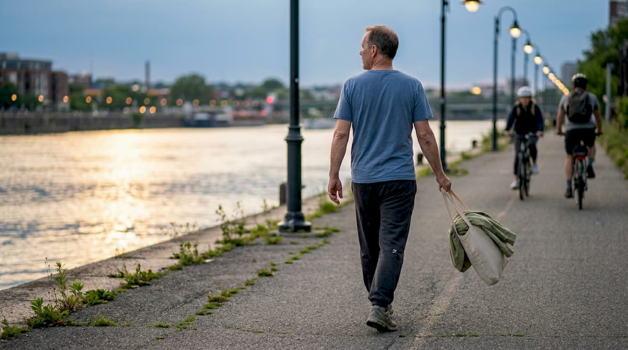 Man walking casually on riverside path
