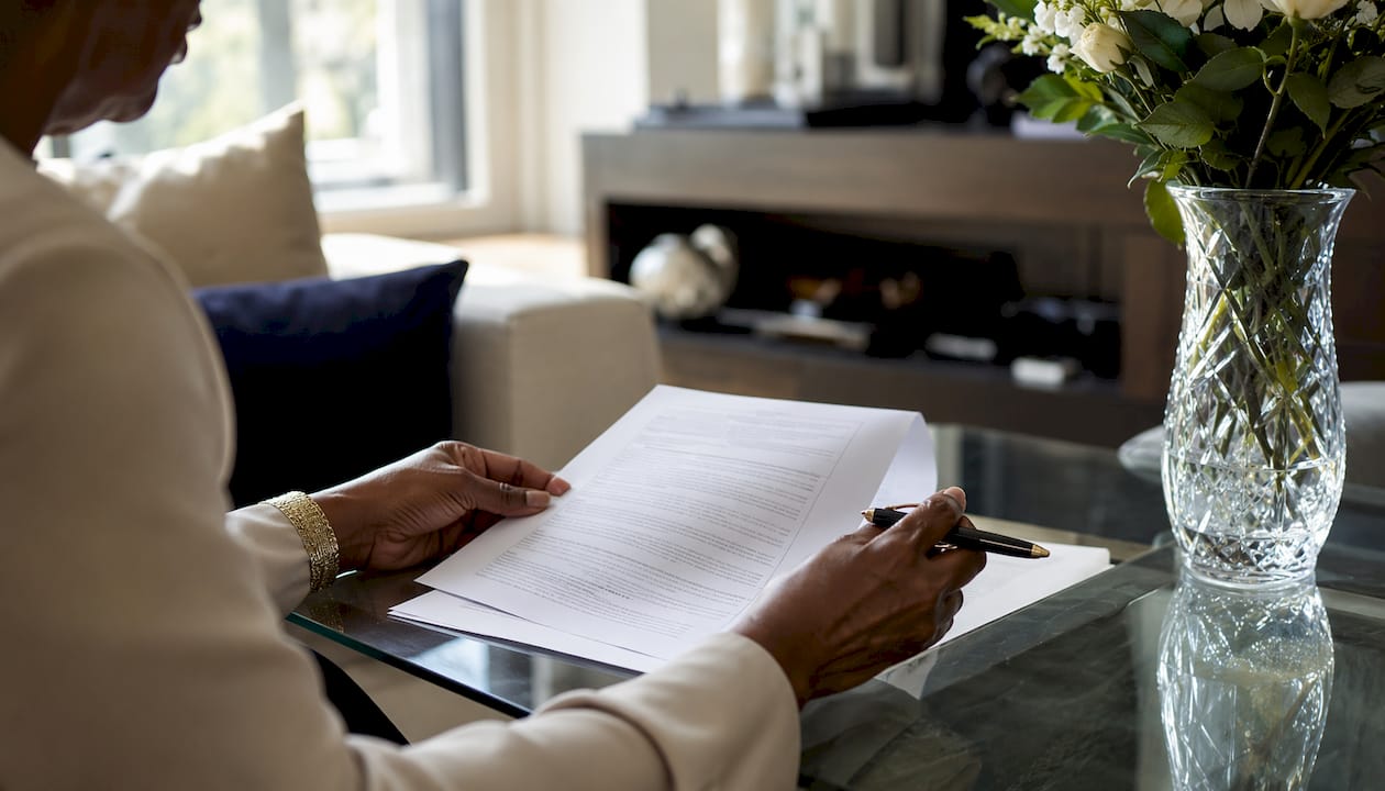 Hands reviewing luxury product warranty document