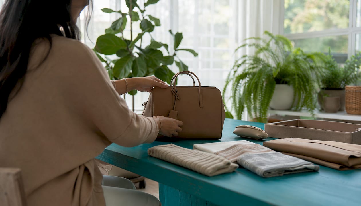 Hands positioning designer bag for photoshoot